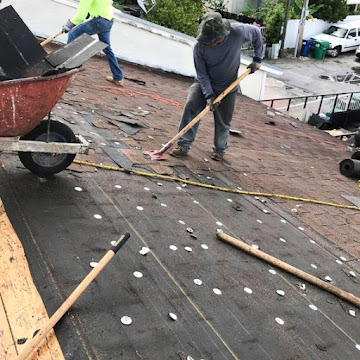 Dumaster Roofing — Roofing crew performing a full tear-off before re-roofing